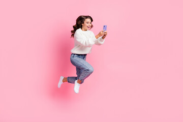 Canvas Print - Full length photo of excited funky lady wear white sweater jumping typing apple samsung device isolated pink color background