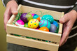 Senior woman hands holding colorful easter eggs
