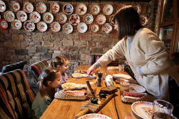 Wall Mural - Family having a meal together in authentic ukrainian restaurant.