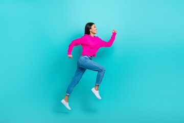 Wall Mural - Full length photo of sweet adorable lady wear pink sweater running fast jumping high isolated turquoise color background