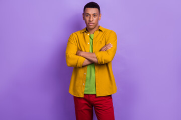 Photo of confident serious guy dressed yellow shirt arms folded isolated purple color background