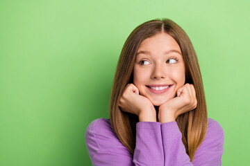 Wall Mural - Portrait of cute cheerful girl long hairstyle purple long sleeve arms on cheekbones look empty space isolated on green color background