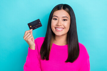 Sticker - Photo portrait of young promoter vietnamese lady hold new premium black debit ebank card promotion shopping isolated on aquamarine color background