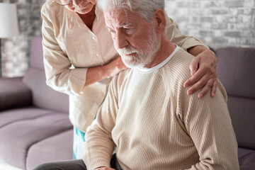 Senior woman comforting her depressed, mental ill husband, unhappy elderly man at home need medical help. Ourmindsmatter