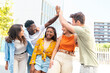 © carlesiturbe - Group of happy multiracial friends having fun outdoors - Cheerful young people laughing together at city - Friendship concept.