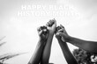 © Media Lens King - Four fists of African people raised to the sky with the words 'Happy Black History Month'