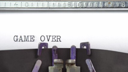 Leinwandbilder - Game Over phrase closeup being typing and centered on a sheet of paper on old vintage typewriter mechanical