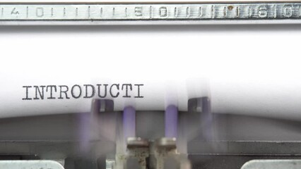 Leinwandbilder - Introduction word closeup being typing and centered on a sheet of paper on old vintage typewriter mechanical