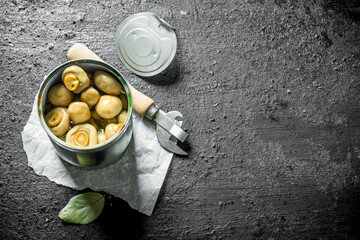 Poster - Canned mushrooms in a tin on paper with a opener.