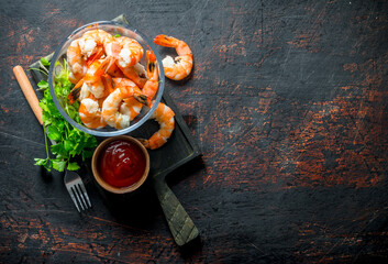 Sticker - Shrimps in a bowl on a cutting Board with parsley and tomato sauce.