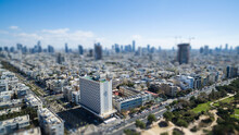 Aerial View Of Tel Aviv Skyline With Urban Skyscrapers, With Cloudy Sky, Israel. Tilt Shift Bokeh Effect For A Miniature Landscape
