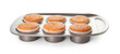 Baking tray with tasty muffins on white background