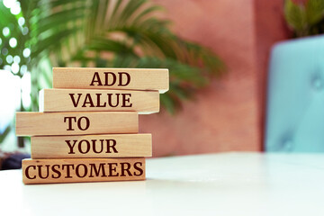 Poster - Wooden blocks with words 'ADD VALUE TO YOUR CUSTOMERS'.