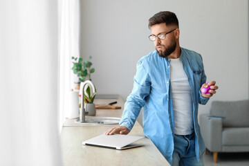 Sticker - Stressed young man squeezing ball at home