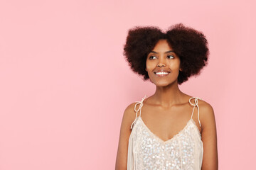 Wall Mural - Portrait of smiling African American woman on pink background. Space for text