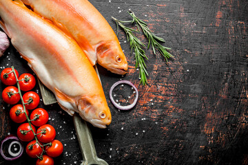 Canvas Print - Raw trout fish with cherry tomatoes, rosemary and onion rings.