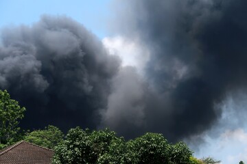  Heavy massive smoke from a warehouse on a huge fire covering the sky over neighborhood in Bangkok,Thailand