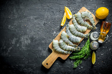 Sticker - Raw shrimps on a cutting Board with lemon slices, spices and dill.