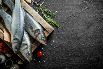 Poster - Raw fish seabass on a tray with the rosemary.