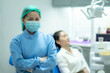 © thebigland45 - Asian woman dentist doctor and female patient in chair smiling at camera, Visiting dentist.