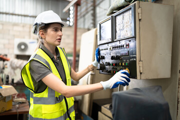 Caucasian engineer woman use monitor control machine at lathe factory	