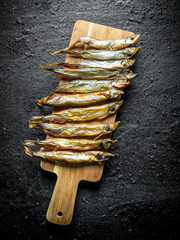 Canvas Print - Smoked fish on a wooden cutting Board.