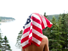 A Boy Poses With The American Flag