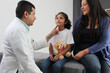 © Arlette - Latina mother cares for and accompanies her curly little daughter at the dark-haired pediatrician specialist doctor's office to prevent abuse and harassment at her medical checkup