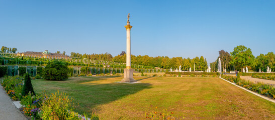 Wall Mural - Panoramic view over garden, pools, flowers, old statues, fountains and many tourists in the city park of Potsdam, a German town of statues and sculptures, Germany, at sunny summer day