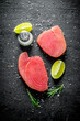 Raw tuna steak with rosemary, lime and salt.