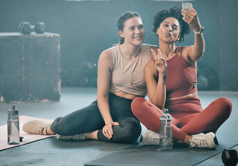 Woman, friends and fitness with phone for selfie, peace sign and pout after workout, exercise or training at gym. Sporty women with smile looking at smartphone for photo or healthy wellness together