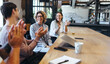 © Jacob Lund - Happy business people applauding during a meeting in an office