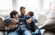 © Grady R/peopleimages.com - Hug, playful and father with children on the sofa for love, care and relax in their family home. Happy, funny and dad with boy kids for quality time, affection and comedy on the couch of a house