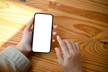 Top view, A woman's hand holding a smartphone white screen mockup