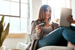 © Grady R/peopleimages.com - Online shopping, credit card and woman with digital tablet on a sofa, relax and smile while checking booking online. Ecommerce, girl and card for banking, credit score or subscription in living room