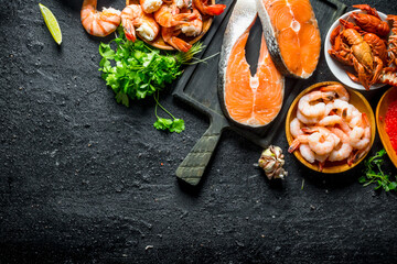 Wall Mural - Fresh salmon steak on a cutting Board with shrimp, crayfish and parsley.