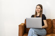 © F8  \ Suport Ukraine - Beautiful woman with a laptop on a couch in a white isolated background