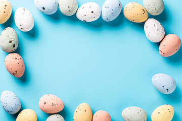 Wall Mural - Easter quail eggs als border frame over blue background. Spring holidays concept with copy space. Top view