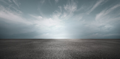 Wall Mural - sky background horizon with dramatic clouds and empty dark asphalt street floor