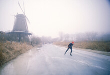 A Young Man Skates On The Road In The Morning, Holland, Europe.