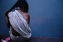 Rear Of A Woman Washing Herself At The Ganges River, Calcutta, India.