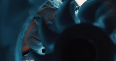 Leinwandbilder - Adult Scientist in Glasses Inspecting a Rotating Fan on an Advanced Turbine Engine. Research and Development Project of a High Tech Jet Engine in an Industrial Facility. Close Up Portrait