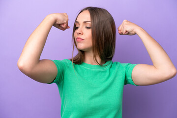 Young caucasian woman isolated on purple background doing strong gesture