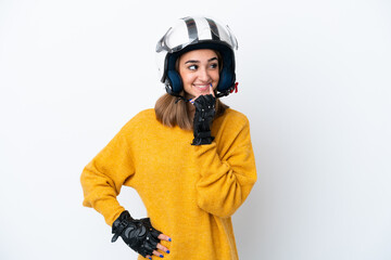 Wall Mural - Young caucasian woman with a motorcycle helmet isolated on white background thinking an idea while looking up