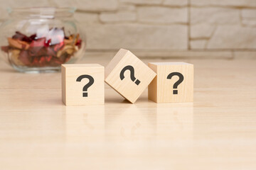 Sticker - three wooden blocks with questions, top view on grey background