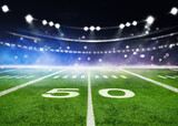 green field in american football stadium. ready for game in the midfield