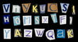 © dule964 - Set letters newspapers scraps isolated on black background and texture, top view, clipping path