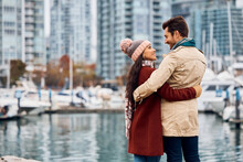 Embraced Couple Talks While Enjoying On City Quay.