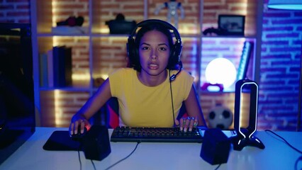 Poster - Young african american woman streamer playing video game with winner expression at gaming room