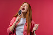 © kohanova1991 - Woman singing, dancing with hair brush instead microphone on pink background. Lady having fun, listening to music, karaoke, dreams of being celebrity.